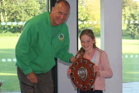 2015 winner Ruby Hodgkinson receiving her shield from Club Chairman Nigel.