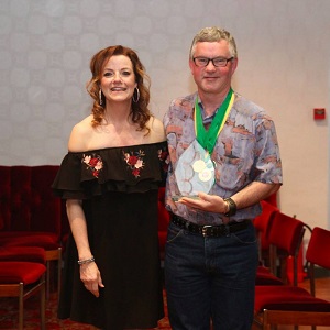 Greg, 2017 winner, receiving the plate from Sue.